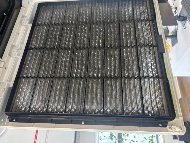 Open indoor cassette filter grille during office maintenance